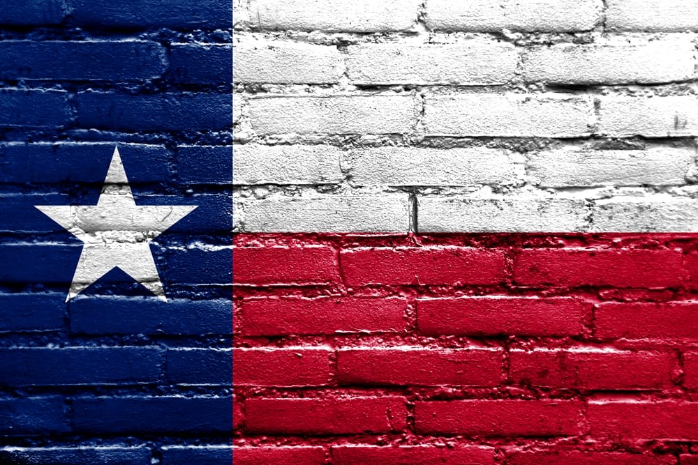 Texas flag painted on the brick wall.