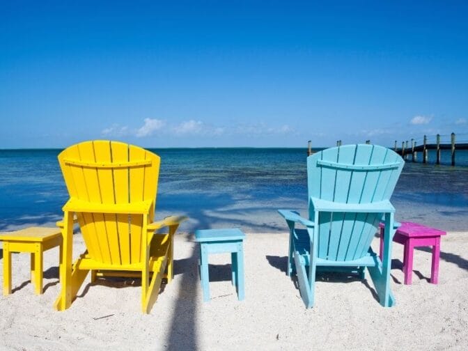 Two chairs on the beach overlooking the ocean are waiting just for you on your romantic Florida Keys getaway