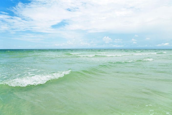 the blue green gulf waters of siesta key beach with blue skies