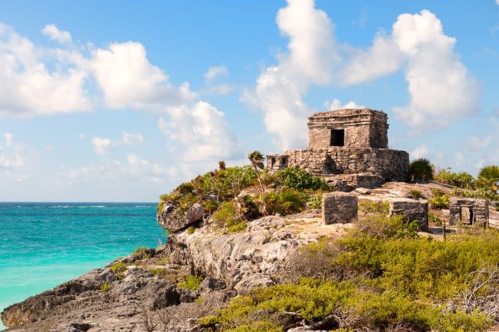 Mayan ruins on a cliff overlooking the water in Tulum, one of the best beaches in Mexico