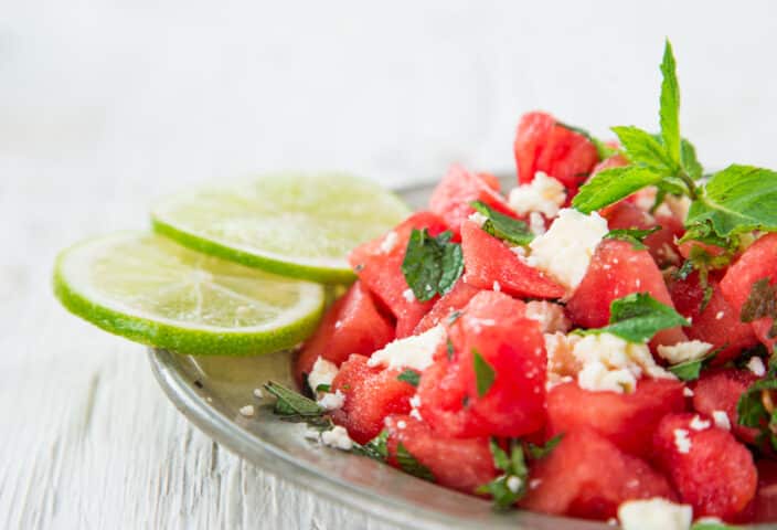 Fresh salad with watermelon, feta cheese, lime and mint, close-up.
