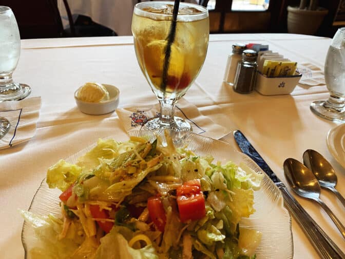 Colombia's 1905 salad on a table with an iced tea