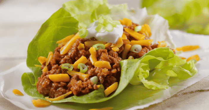 Tacos with ground beef and cheese using lettuce as the shell