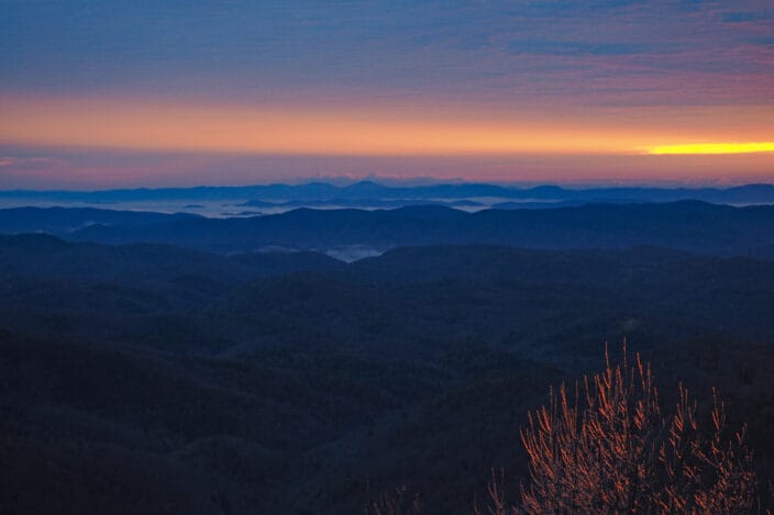 Colorful sunrise over layered mountains in Blowing Rock, North Carolina.