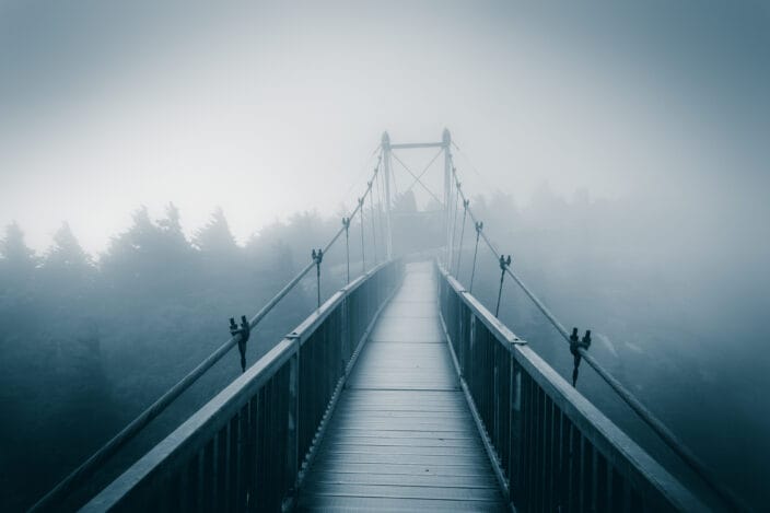 Swinging bridge in the North Carolina mountains, with fog
