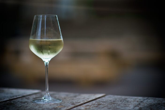 Glass of white wine on a wood slats