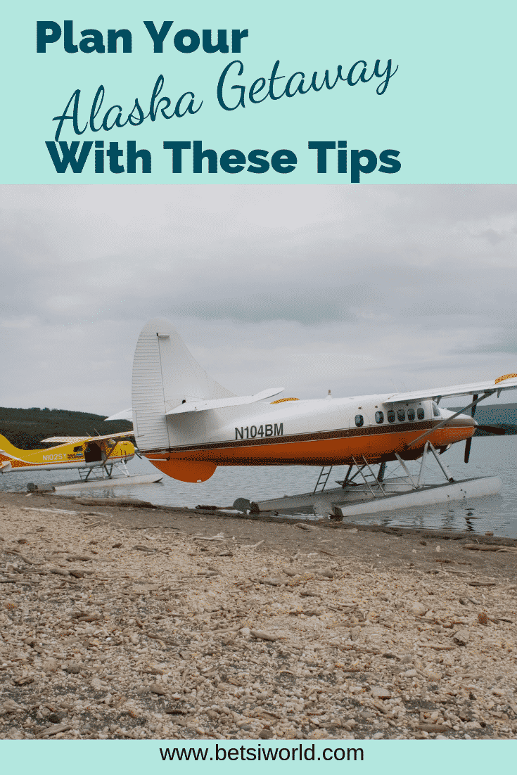 Seaplanes are an easy way to see Alaska. White and orange sea plane on the rocky beach