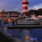 red and white lighthouse at Hilton Head, South Carolina. dusk. hotel and marina