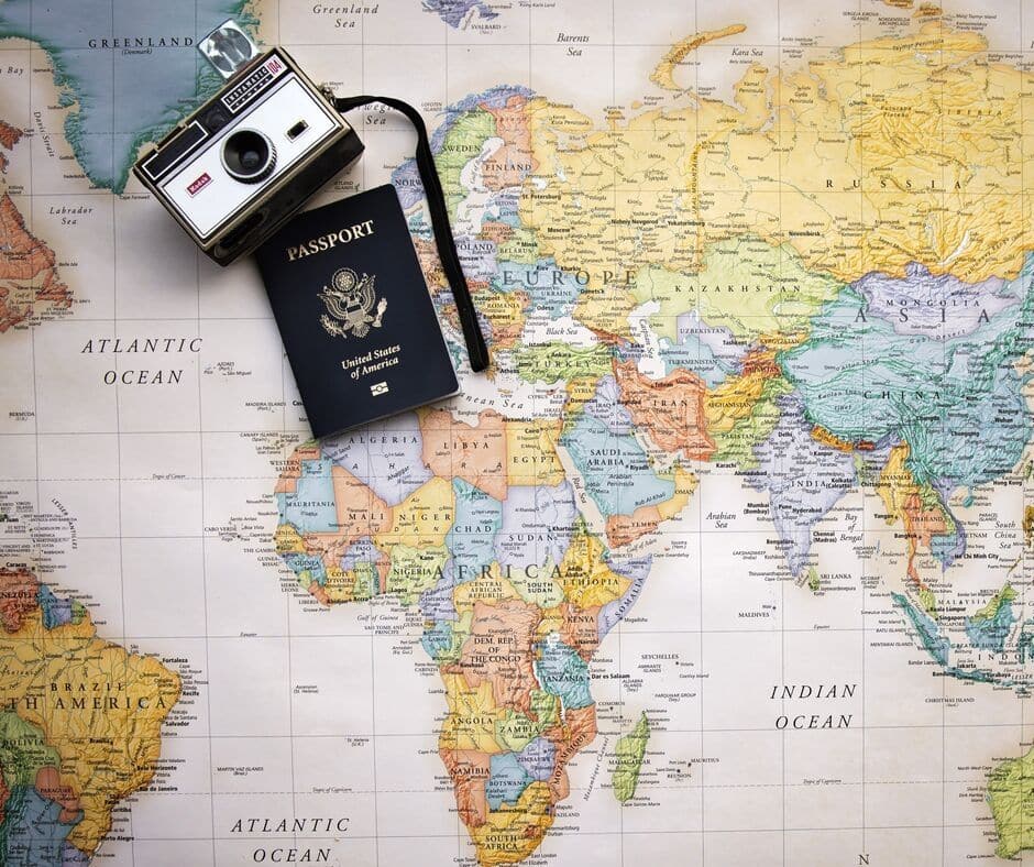 Featured image showing a map and passport with a camera
