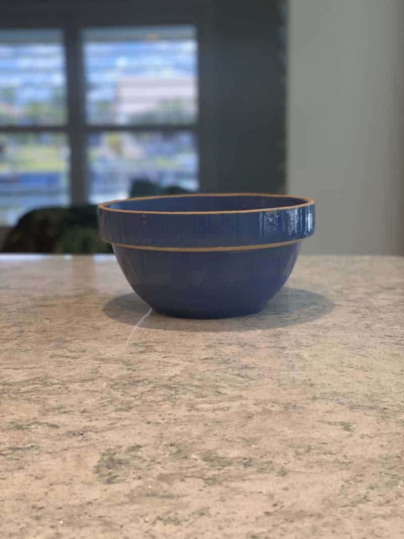 a blue bowl on counter used for making biscuits