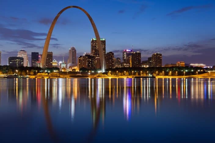 Image of St. Louis downtown with Gateway Arch at twilight, a romantic weekend getaway destination.
