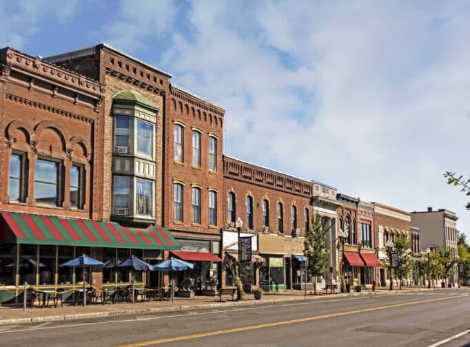 Mainstreet view of downtown with old brick buildings, colored awnings, shops and restaurants