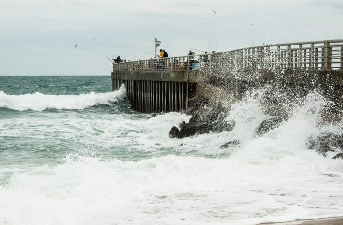 a group of people fishing on a pier near Vero Beach, Fl
